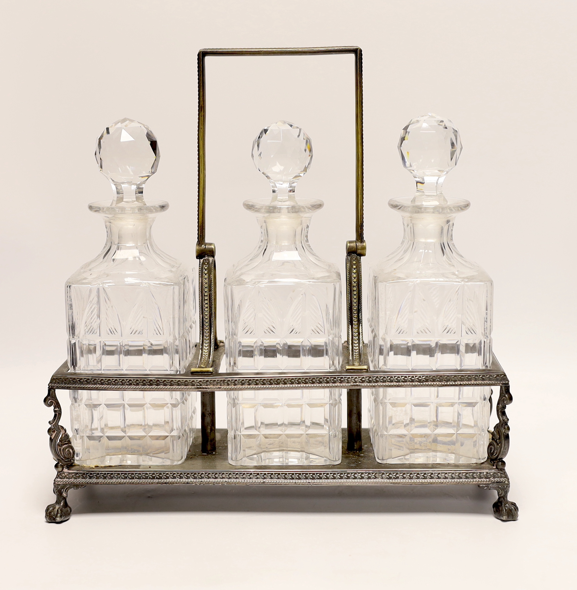 A silver plated three decanter tantalus